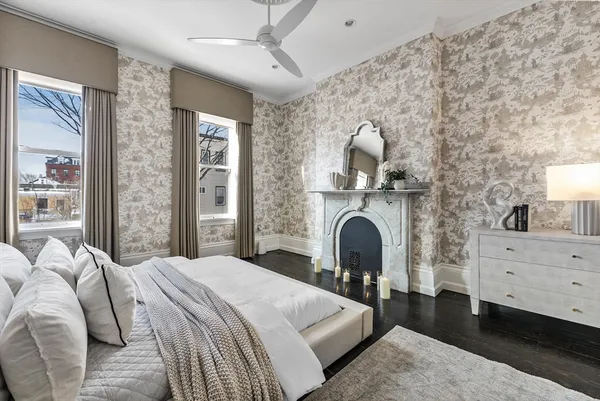 a bedroom with a bed and a fireplace