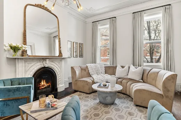a living room with furniture and a fireplace