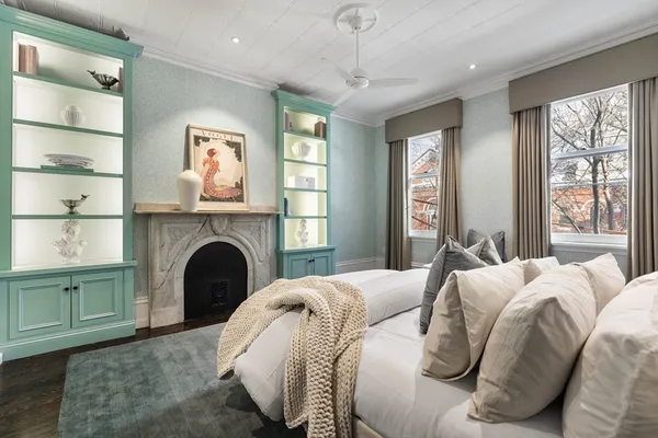 a bed room with a bed and a fireplace