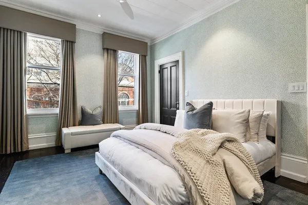 a bedroom with a bed and glass door