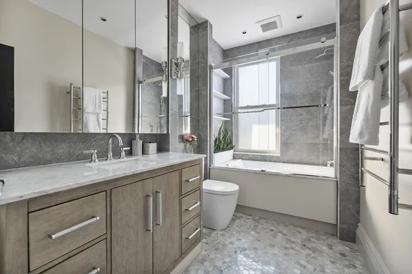 a bathroom with a granite countertop sink toilet and shower