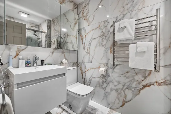 a bathroom with a sink toilet and shower