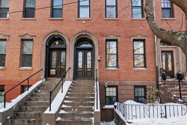 a view of a brick house with large windows