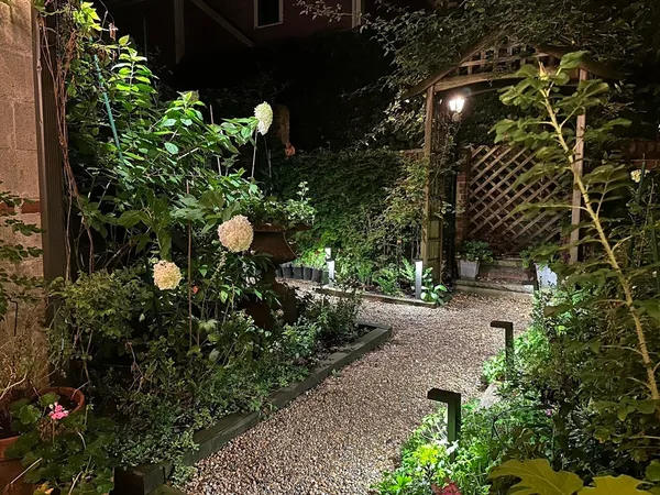 a backyard of a house with lots of green space and a fountain