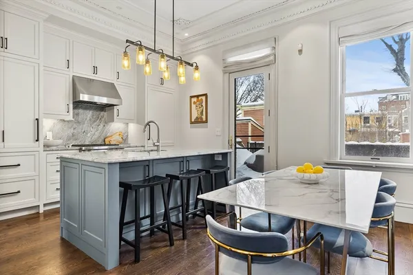 a kitchen with granite countertop a sink cabinets and window