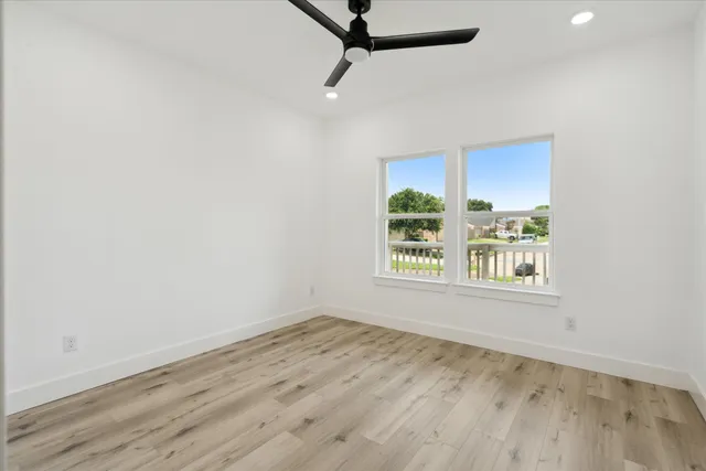 a view of a room with wooden floor