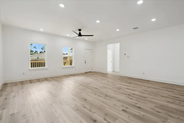 a view of a livingroom with wooden floor and white walls