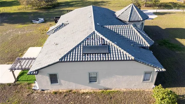 an aerial view of a house with yard