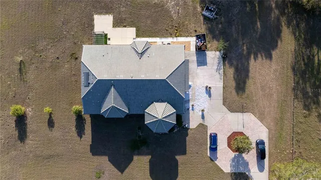 a kitchen with stainless steel appliances granite countertop a refrigerator and a view of living room