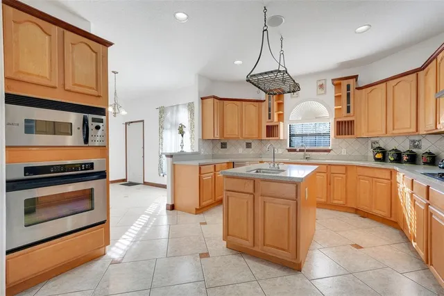 a view of a kitchen with a sink and chandelier