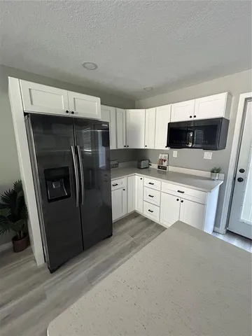 a close view of a sink and dishwasher with wooden floor