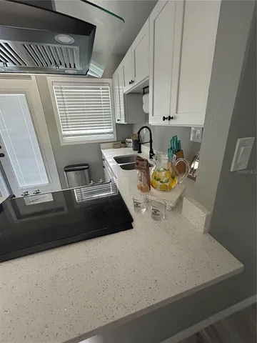 a kitchen with a stove a microwave and wooden floor