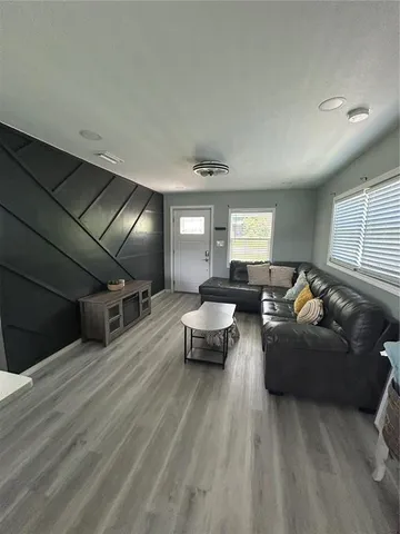 a kitchen with stainless steel appliances a sink a stove top oven a chimney and a window