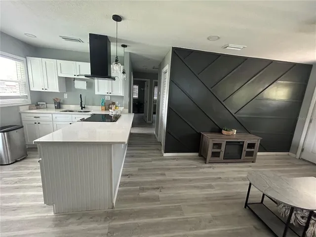 a kitchen with a sink stove and cabinets