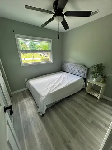 a bedroom with a bed and a window