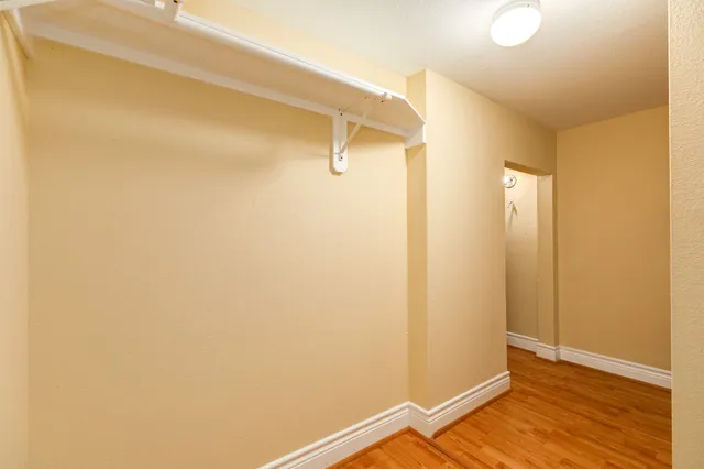 a view of a room with wooden floor