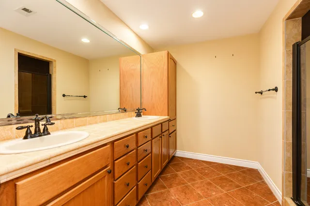 a bathroom with a double vanity sink and a mirror