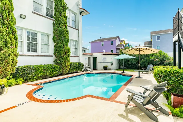 a swimming pool with outdoor seating and yard