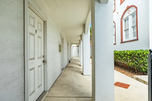 wooden floor with a view of a bathroom