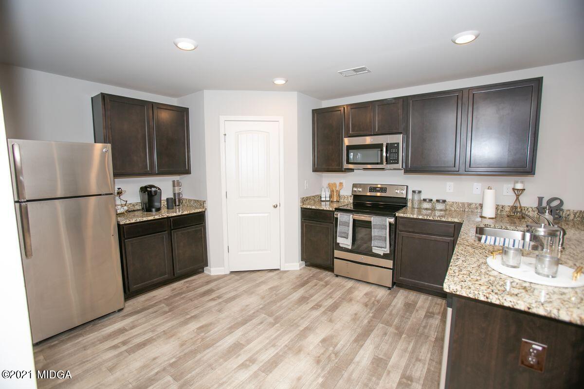 103 Sara Kay Lane, Unit 37 Macon, GA 31210 - Photo 18 of 38 a kitchen with granite countertop a refrigerator stove top oven and sink