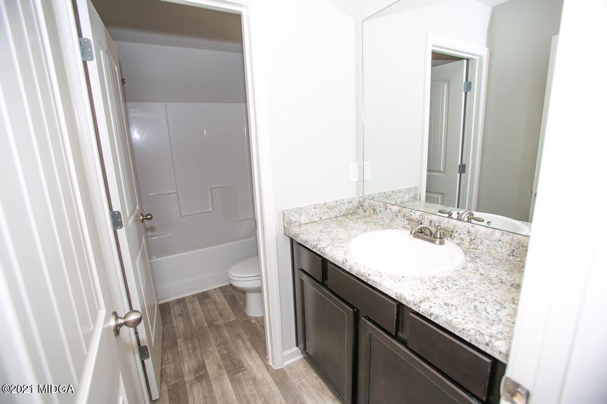 103 Sara Kay Lane, Unit 37 Macon, GA 31210 - Photo 23 of 38 a bathroom with a granite countertop sink and a mirror