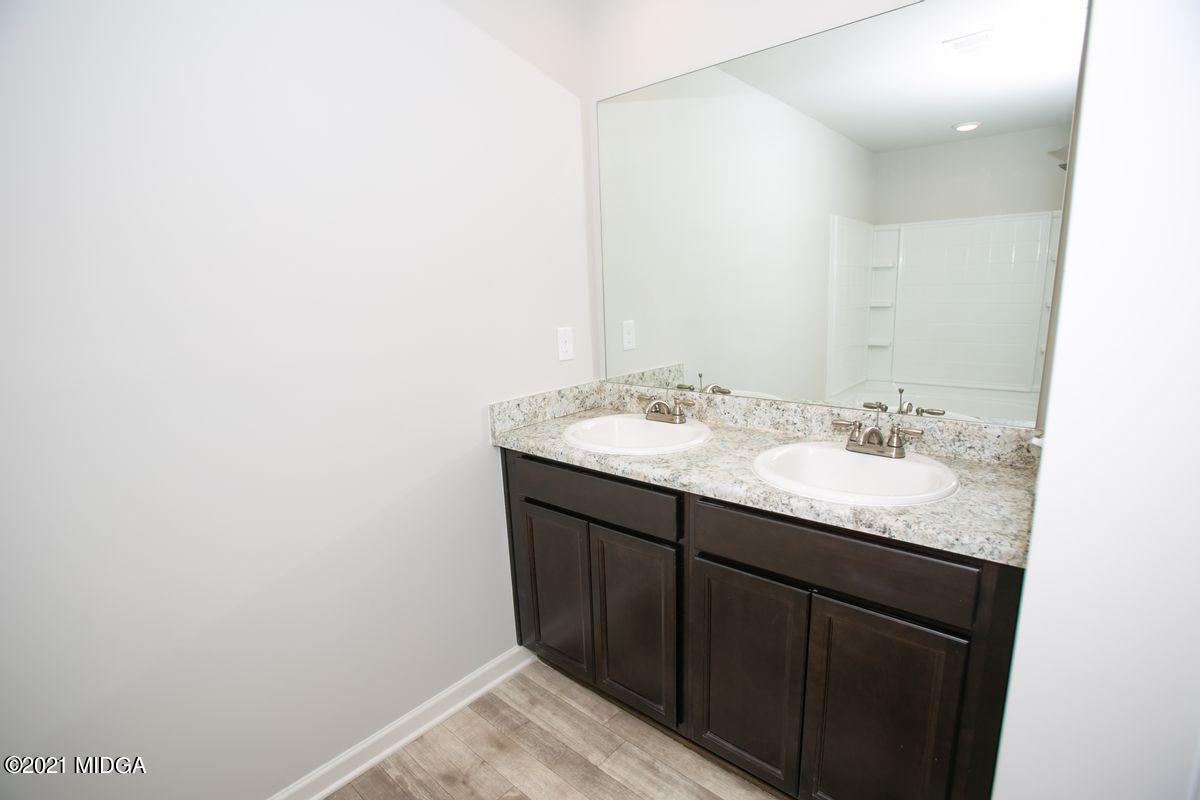 103 Sara Kay Lane, Unit 37 Macon, GA 31210 - Photo 32 of 38 a bathroom with a granite countertop sink and a mirror