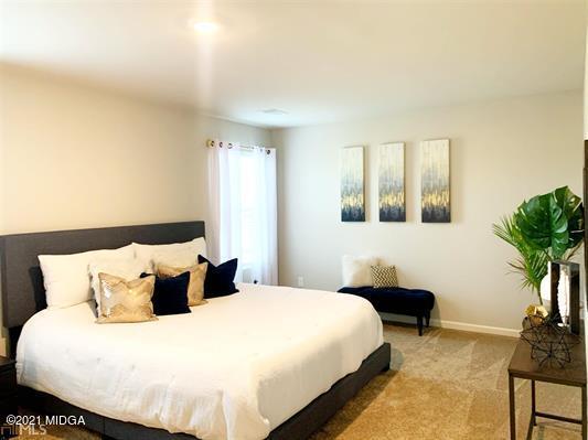 103 Sara Kay Lane, Unit 37 Macon, GA 31210 - Photo 38 of 38 a bedroom with a bed and a potted plant