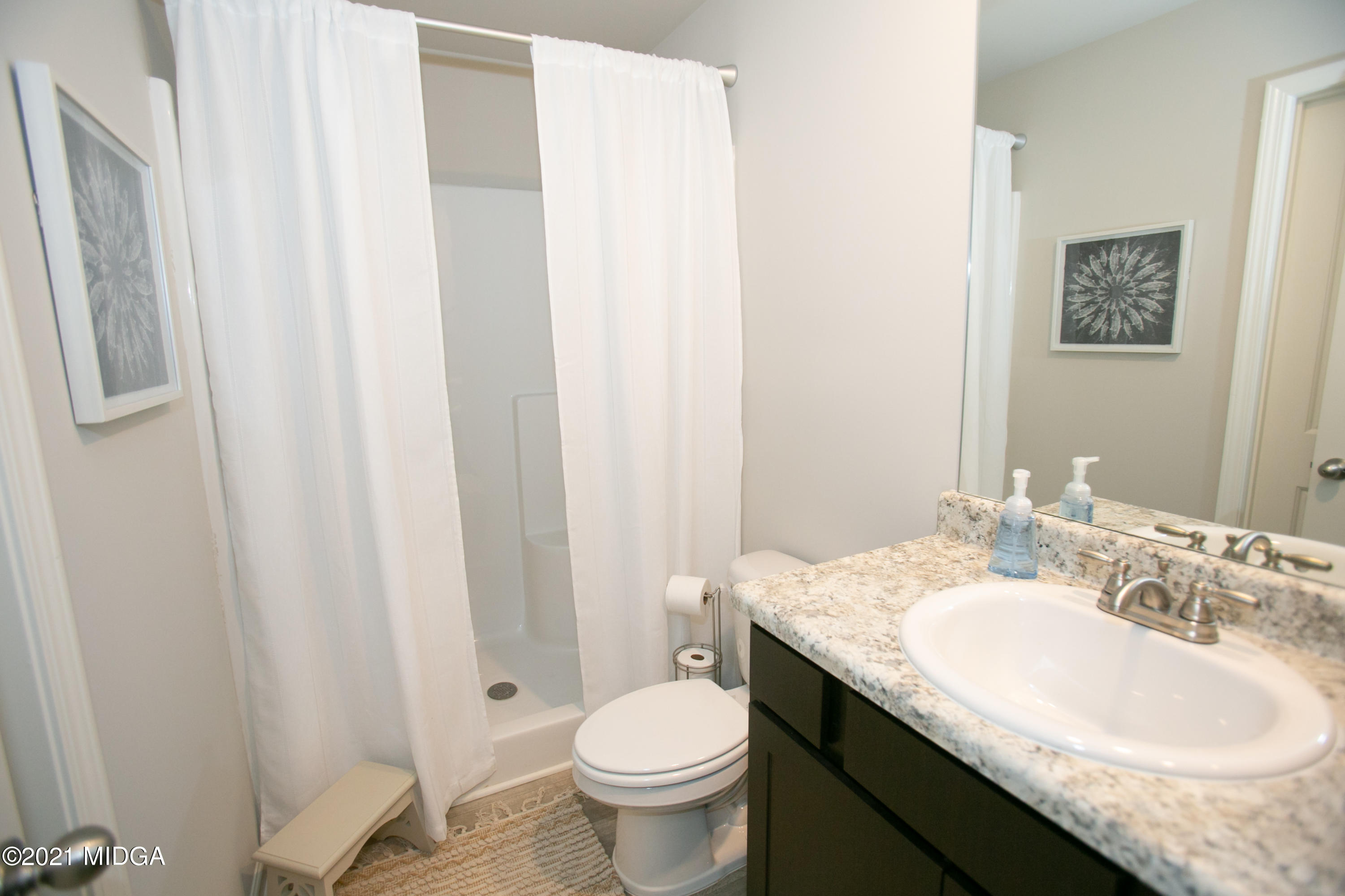 103 Sara Kay Lane, Unit 37 Macon, GA 31210 - Photo 4 of 38 a bathroom with a granite countertop sink toilet and a mirror