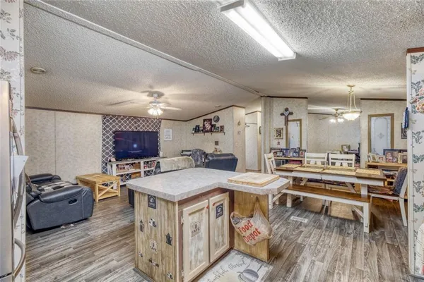 a room with furniture a flat screen tv and a wooden floor