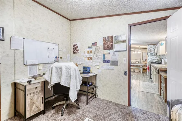 a living room with furniture a flat screen tv and a table