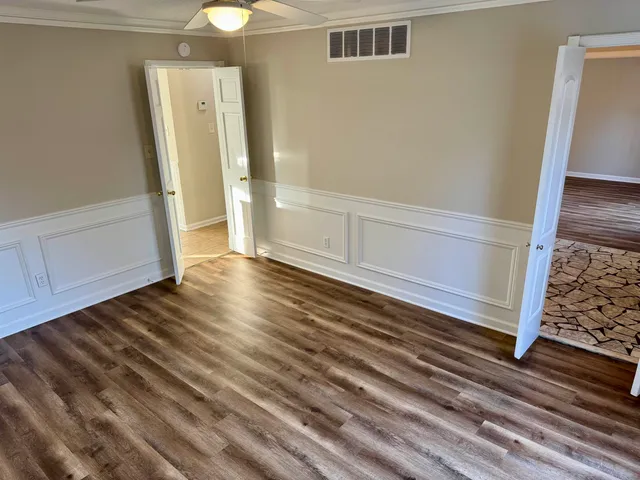 a view of a room with wooden floor