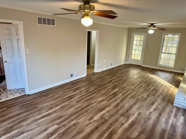 wooden floor in an empty room with a window