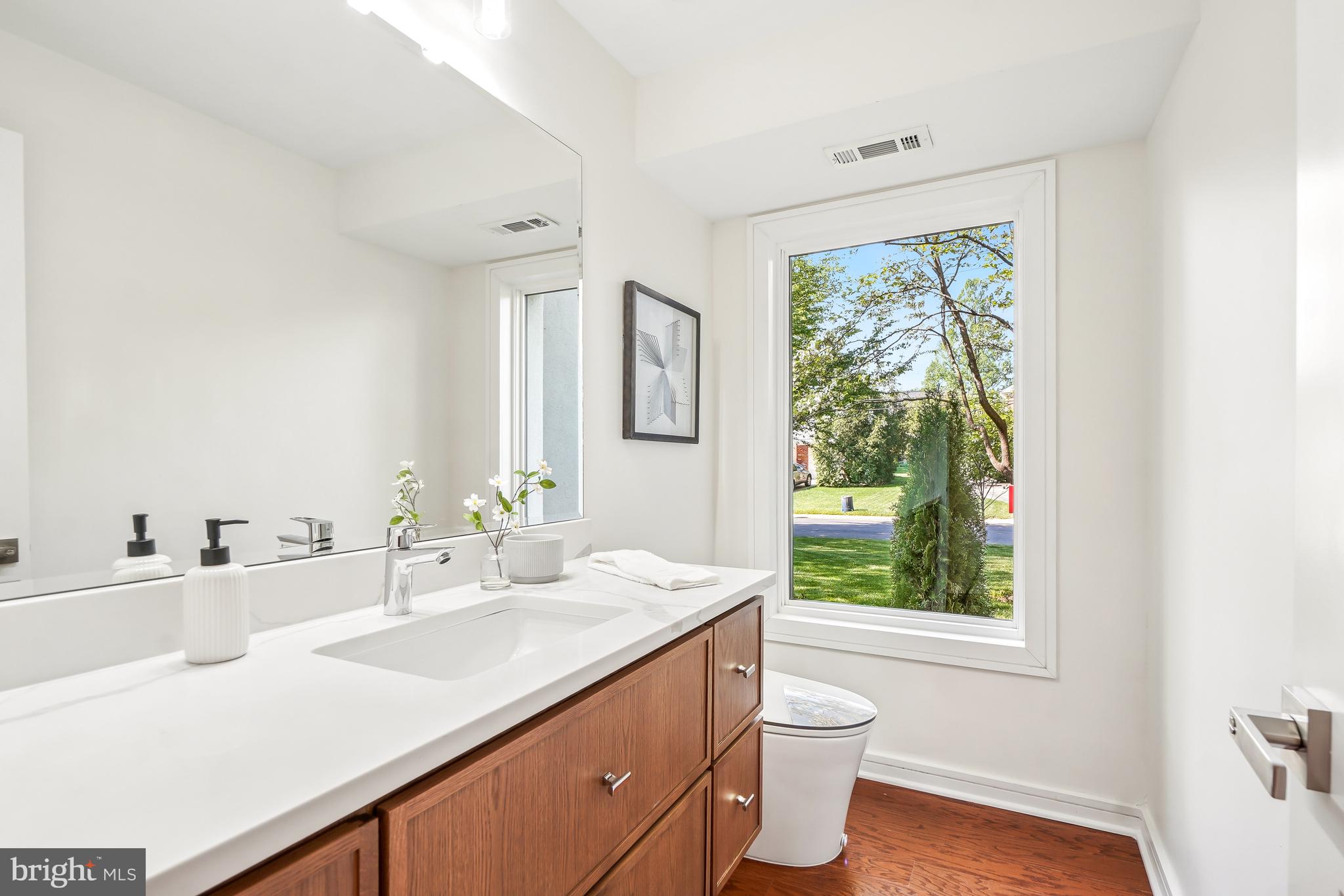 7301 Marbury Road Bethesda, MD 20817 - Photo 26 of 81 a bathroom with a granite countertop sink toilet and a large mirror