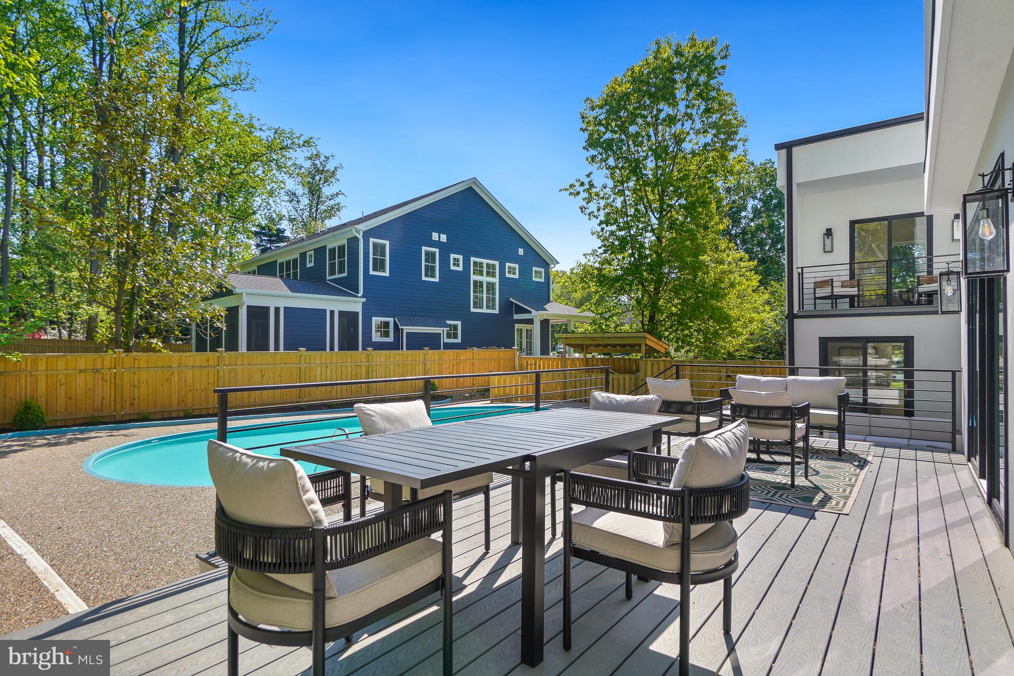 7301 Marbury Road Bethesda, MD 20817 - Photo 69 of 81 a view of a patio with table and chairs with wooden floor and fence