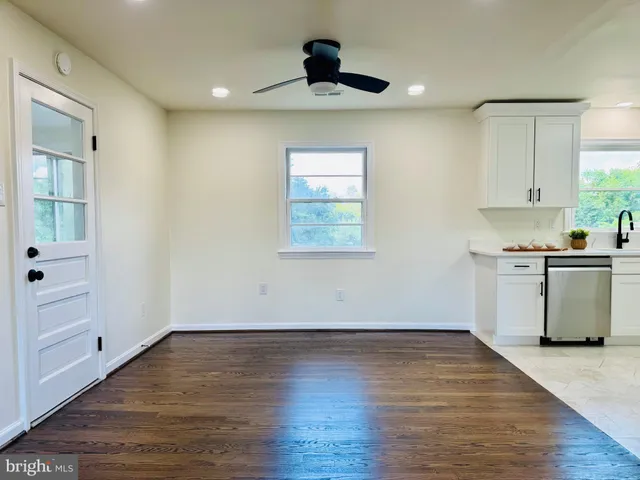 a kitchen with stainless steel appliances granite countertop a refrigerator sink and stove