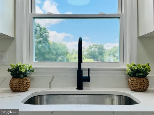 a kitchen with a stove and white cabinets