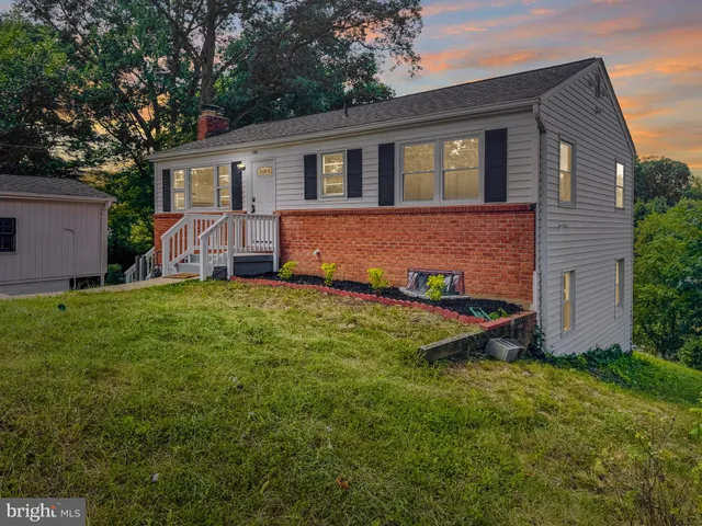 a view of a house with a yard and sitting area