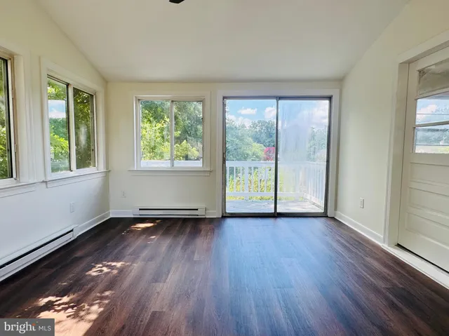 a balcony with wooden floor and outdoor space