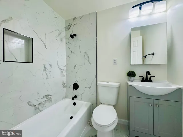 a view of an empty room and wooden floor