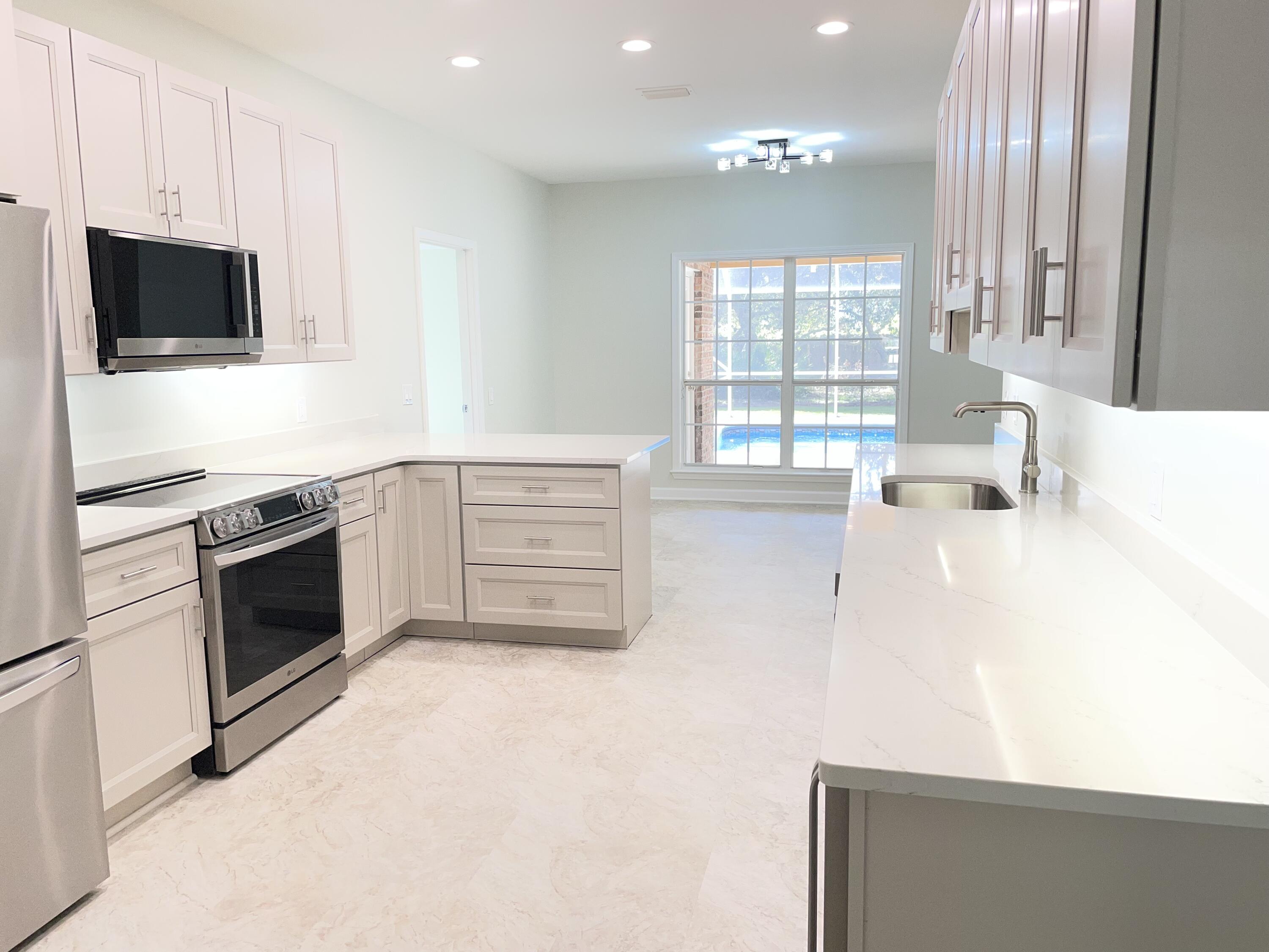 3 Walton Way Miramar Beach, FL 32550 - Photo 11 of 35 a kitchen with stainless steel appliances a stove sink and microwave