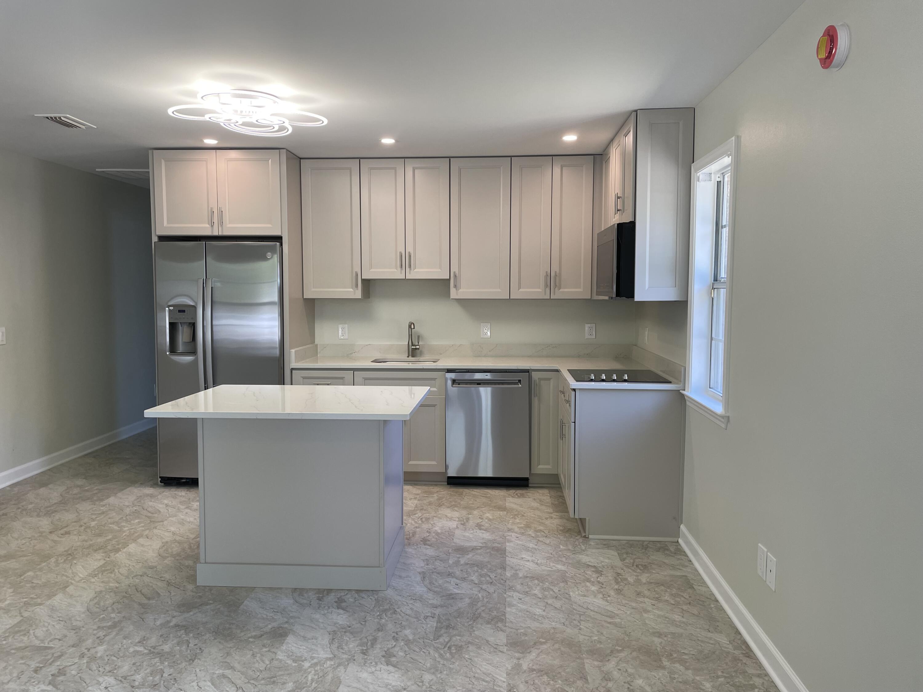 3 Walton Way Miramar Beach, FL 32550 - Photo 22 of 35 a kitchen with kitchen island granite countertop a sink cabinets and stainless steel appliances
