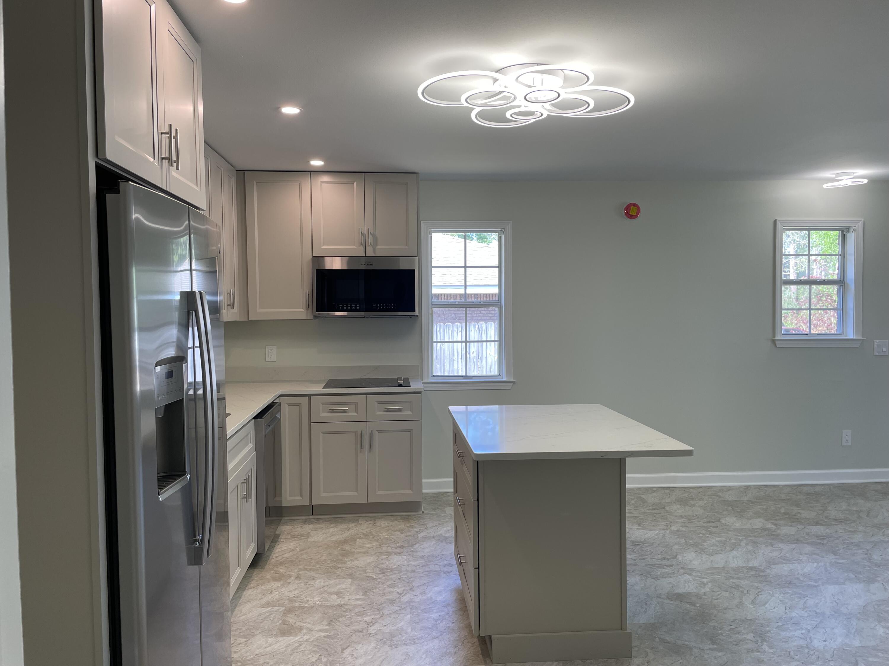 3 Walton Way Miramar Beach, FL 32550 - Photo 23 of 35 a kitchen with stainless steel appliances granite countertop a refrigerator a sink dishwasher a stove and a refrigerator with wooden floor