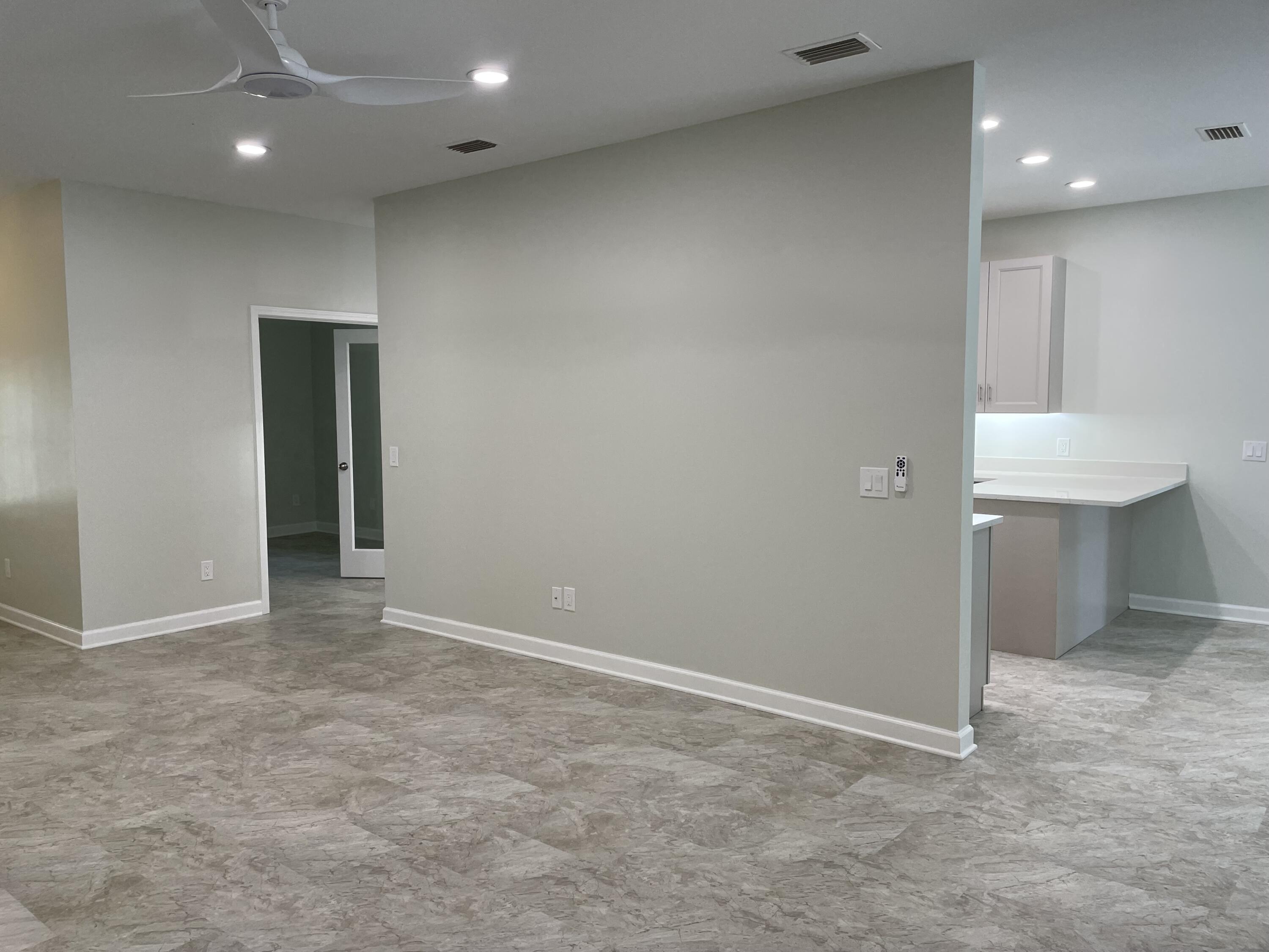 3 Walton Way Miramar Beach, FL 32550 - Photo 6 of 35 an empty room with wooden cabinet and entryway