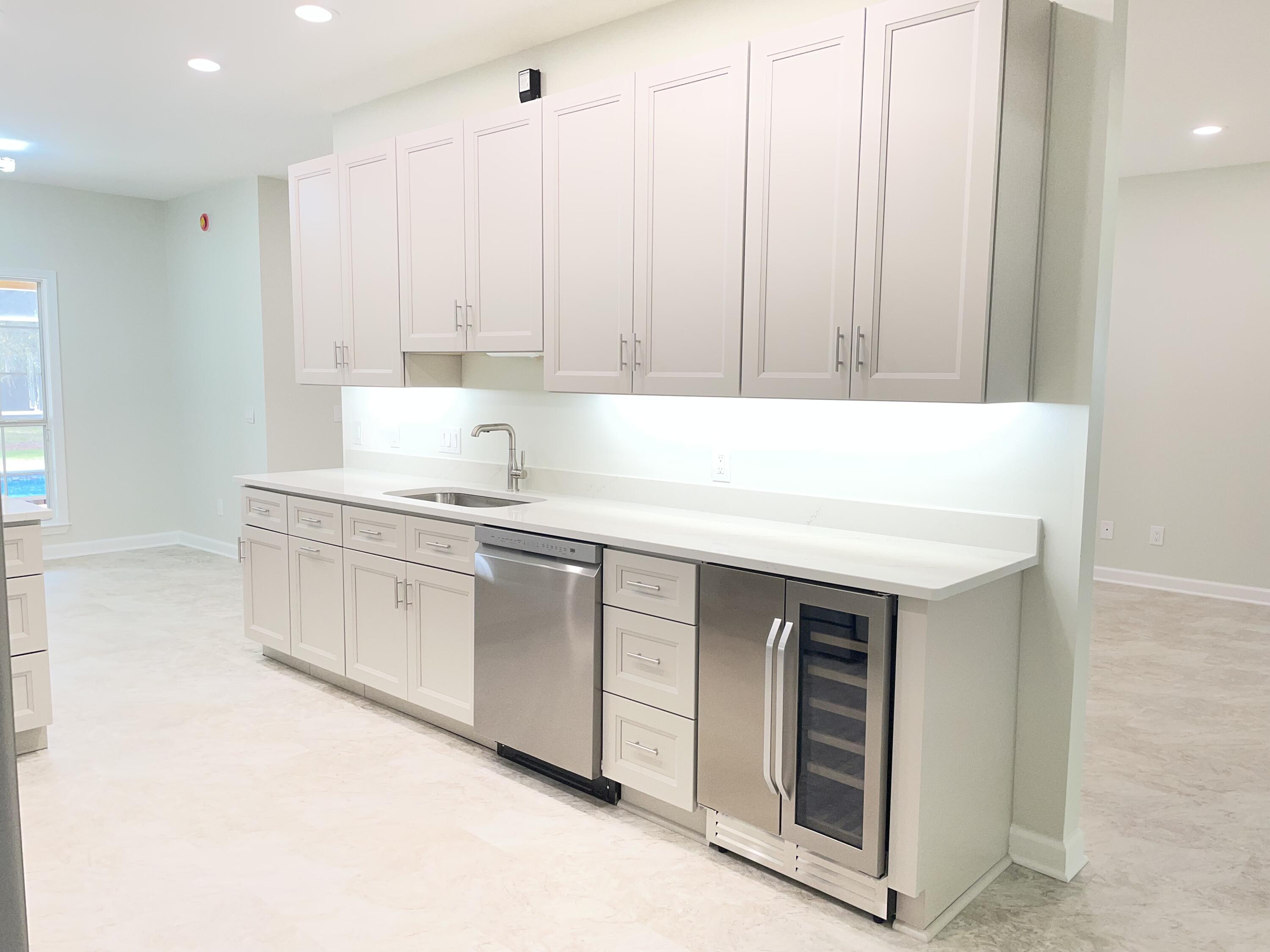 3 Walton Way Miramar Beach, FL 32550 - Photo 9 of 35 a kitchen with granite countertop white cabinets and white appliances