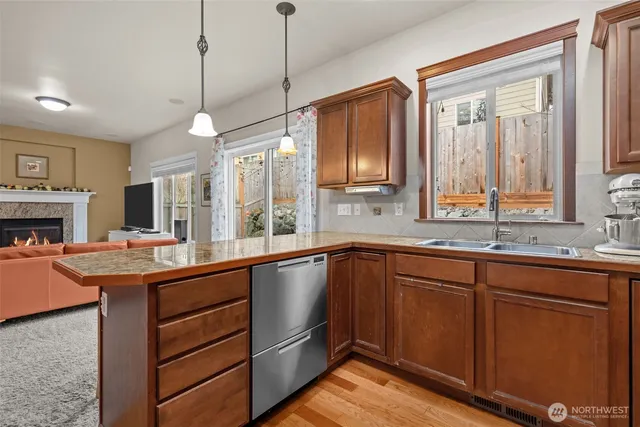 a kitchen with a sink stove and wooden cabinets