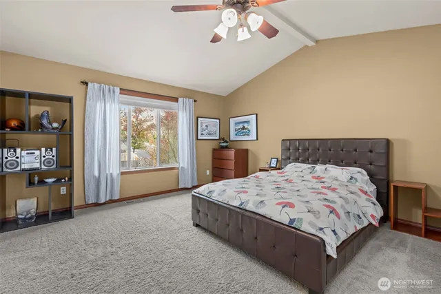 a bedroom with a large bed and a chandelier