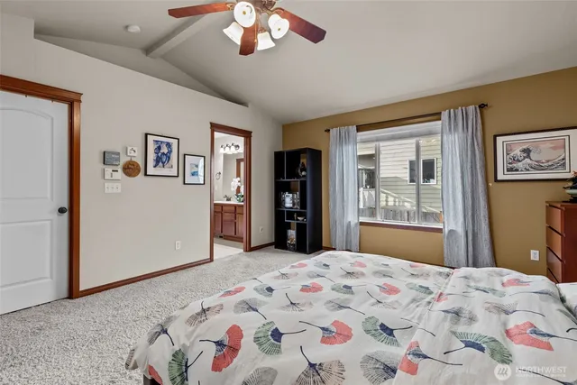 a bedroom with a large bed and a chandelier