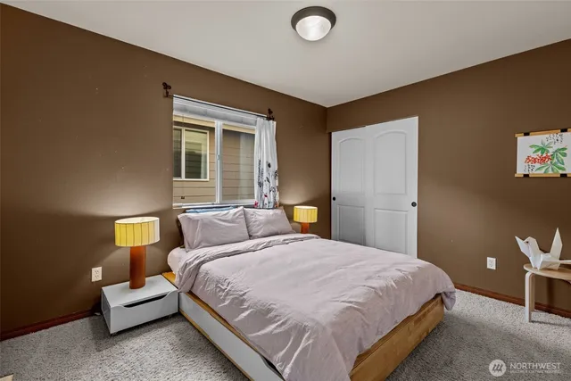 a bedroom with a bed and a lamp