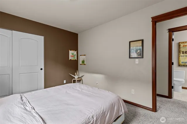 a bedroom with a bed and wall painting