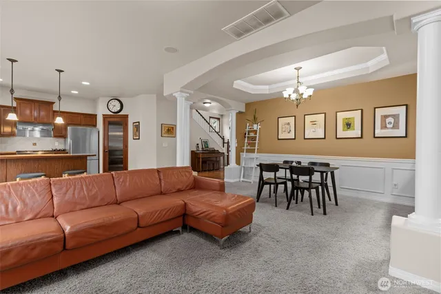 a living room with furniture and a dining table